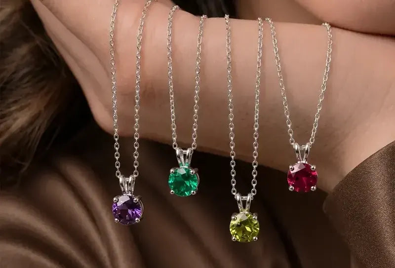 Gemstone pendant necklaces draped over a hand